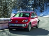 VW Cross Up! front 3/4 on road in trees close up image