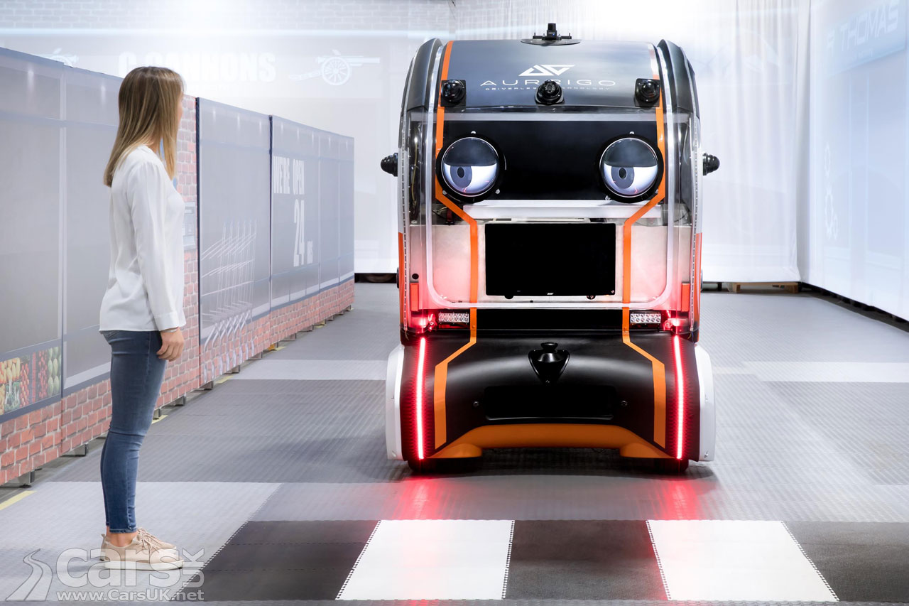 Jaguar LAnd Rover autonomous driving pod making eye contact with a pedestrian at a zebra creossing