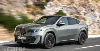 BMW iX4 front view on road