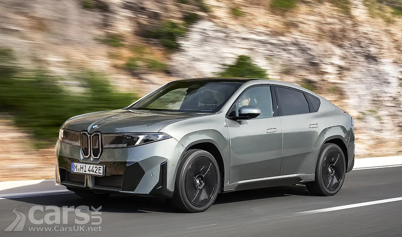 BMW iX4 front view on road
